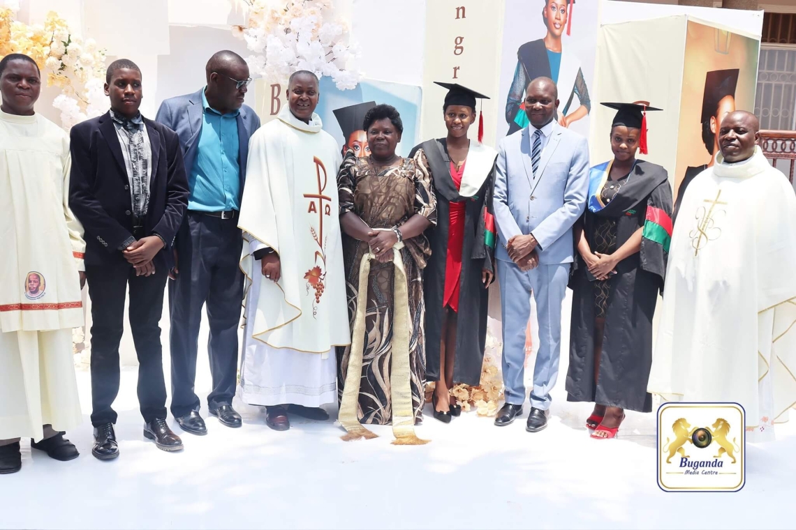 Cossy Baagala celebrates her graduation with family, fellow graduates, Owek. Noah Kiyimba, and Rev. Fr. Robert Mayiga at a ceremony in Lwadda Cossy Baagala celebrates her graduation with family, fellow graduates, Owek. Noah Kiyimba, and Rev. Fr. Robert Mayiga at a ceremony in Lwadda